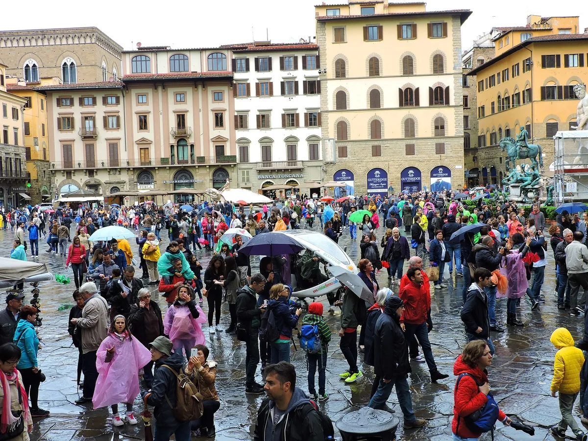 People walking across Piazza della Signoria in the historic center of Florence