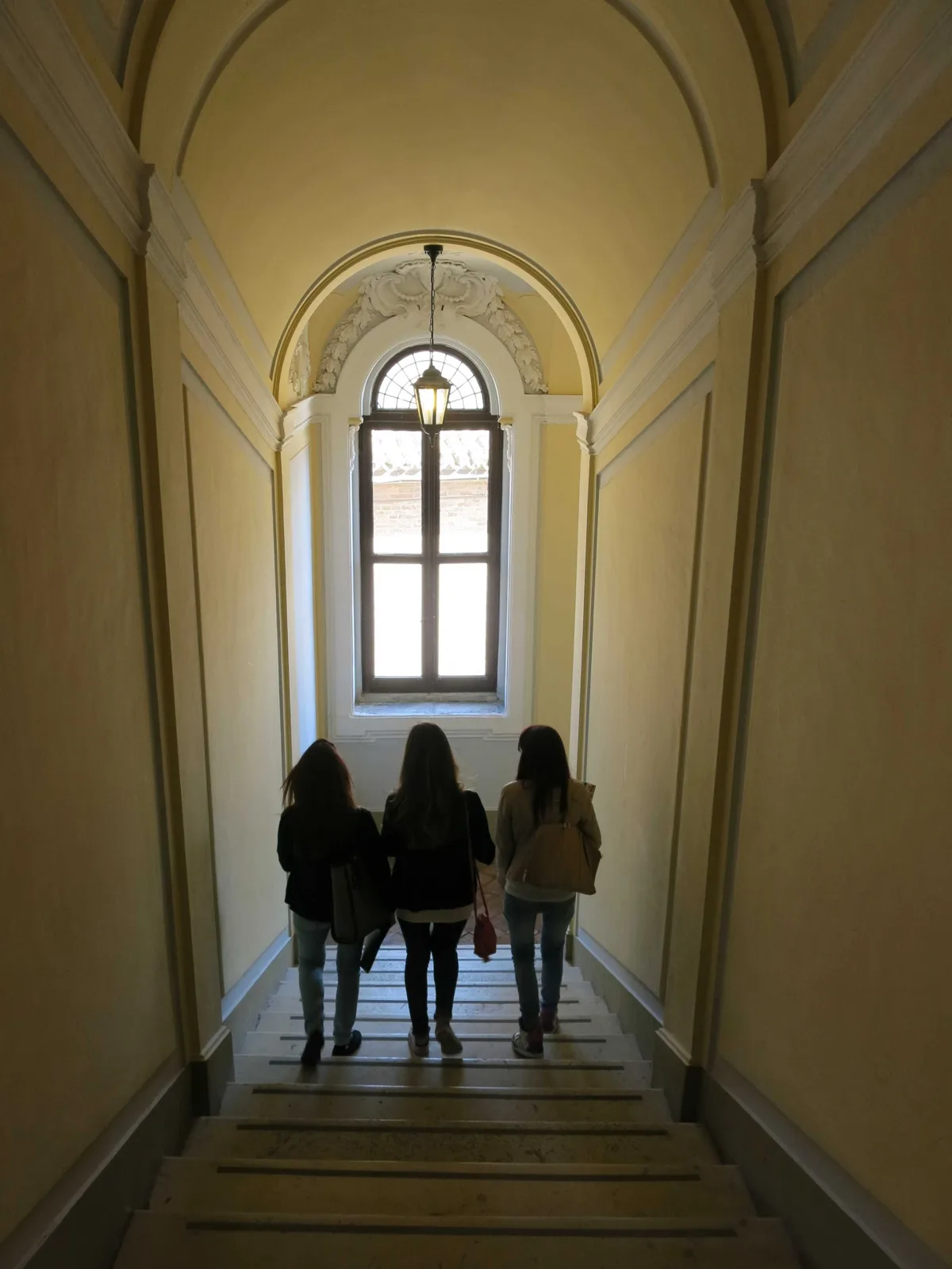 Students descending the staircase of Palazzo Albani in Florence